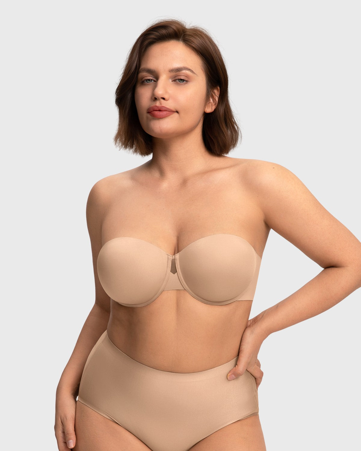 Confident woman wearing the almond skin invisible padded strapless bra, experiencing gentle shaping and superior, silicone-free hold.