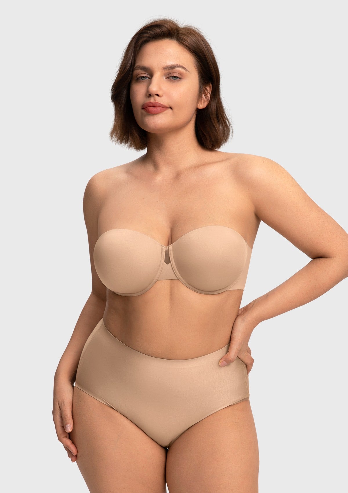 Confident woman wearing the almond skin invisible padded strapless bra, experiencing gentle shaping and superior, silicone-free hold.