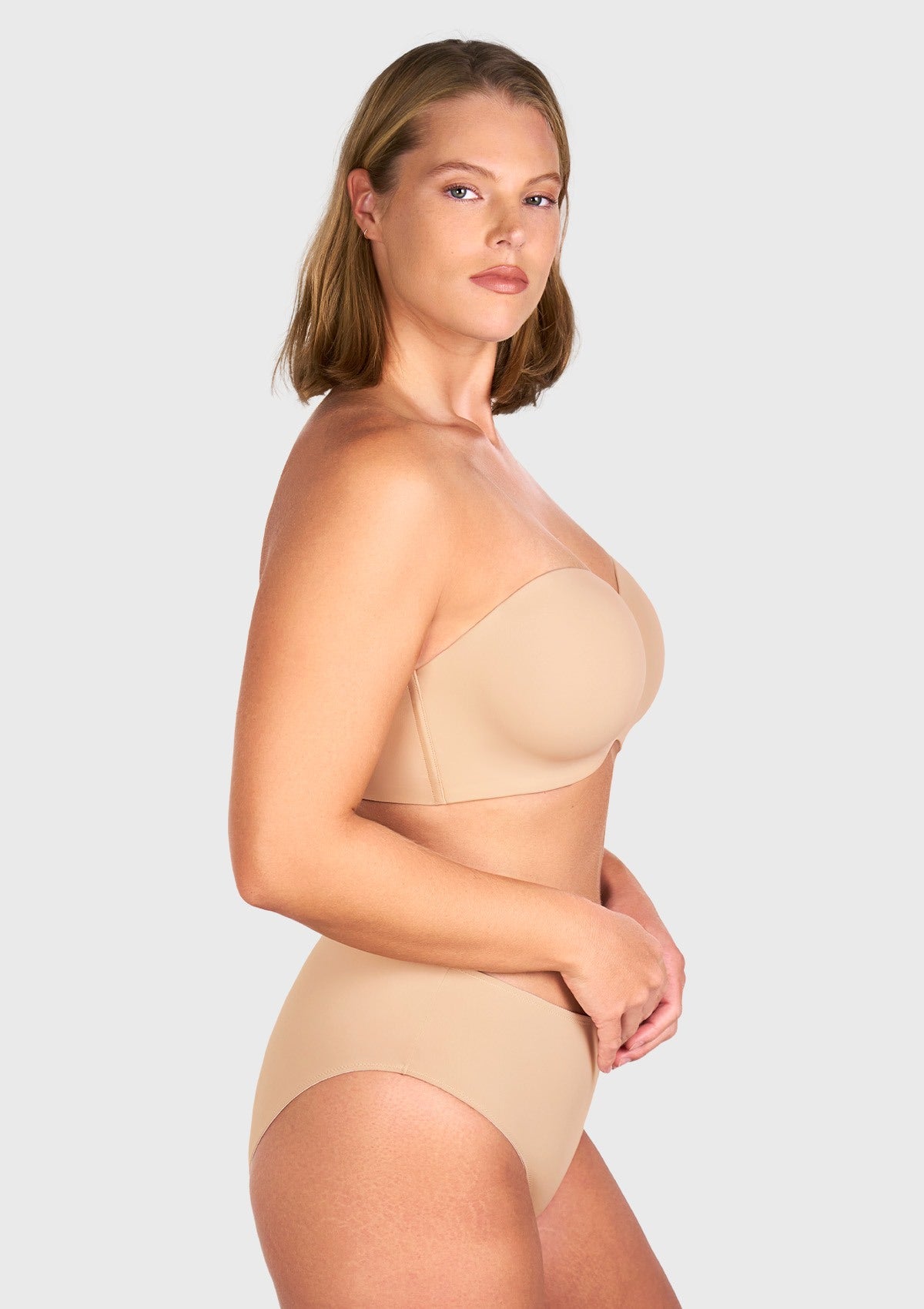 Side profile showing the lift and full coverage support of the black strapless bra