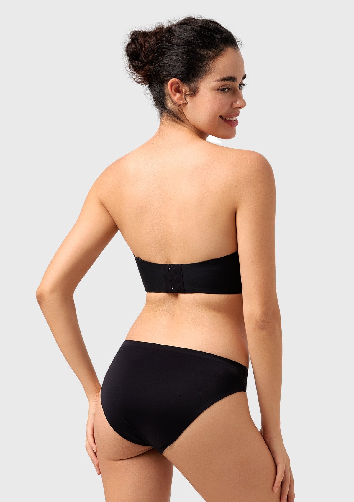 Rear view of the black best wireless bra showing the seamless invisible back closure that prevents bulging under tight dresses.