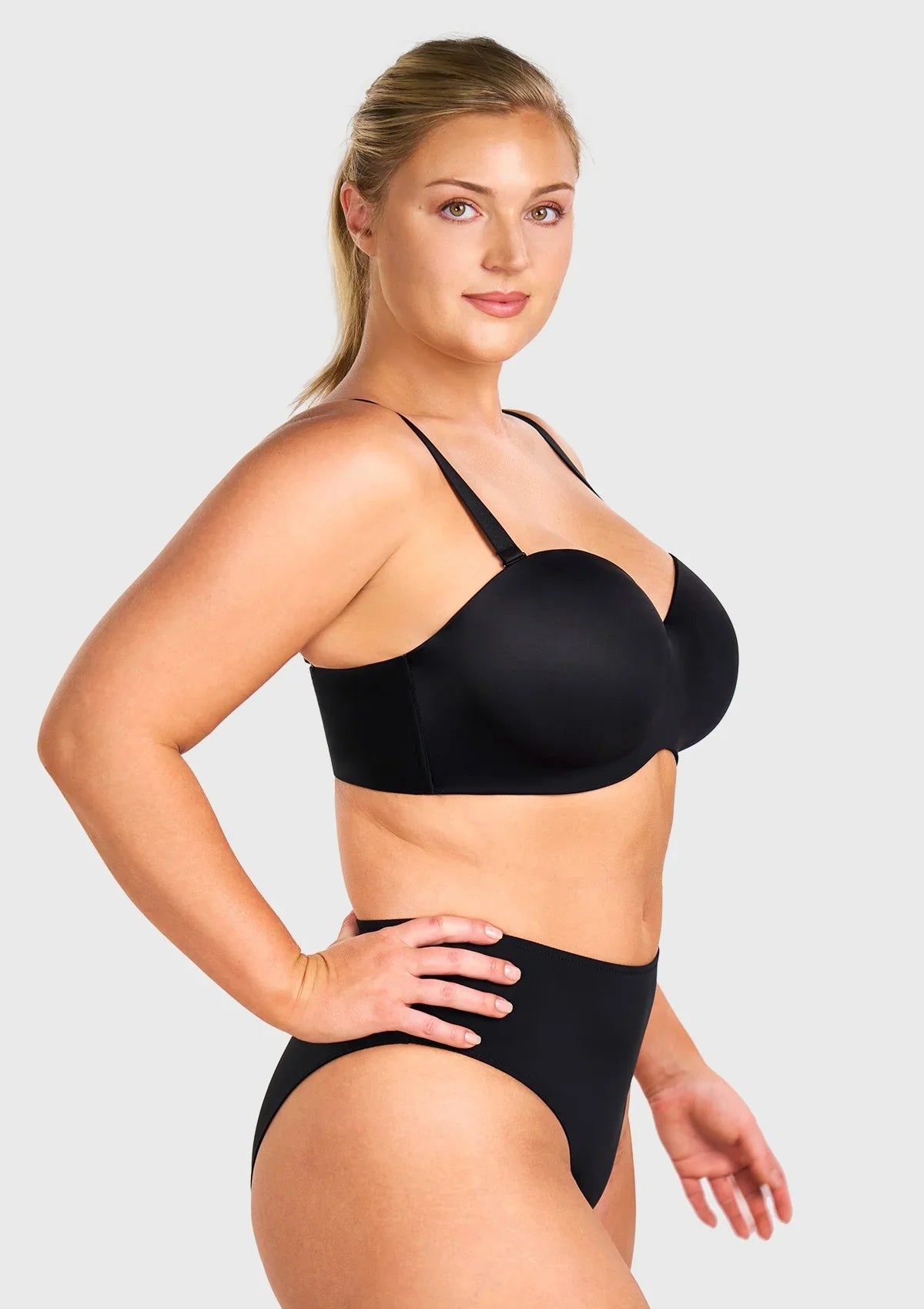 Side profile showing the lift and full coverage support of the black strapless bra