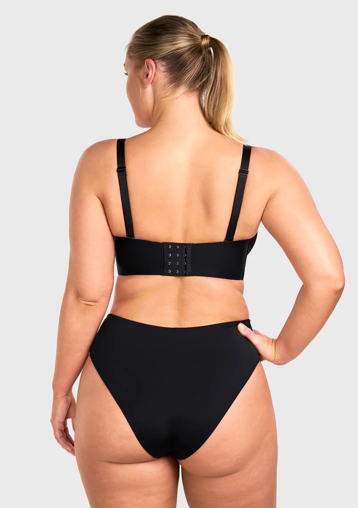 Close-up showing both matching black straps and bonus clear invisible straps included