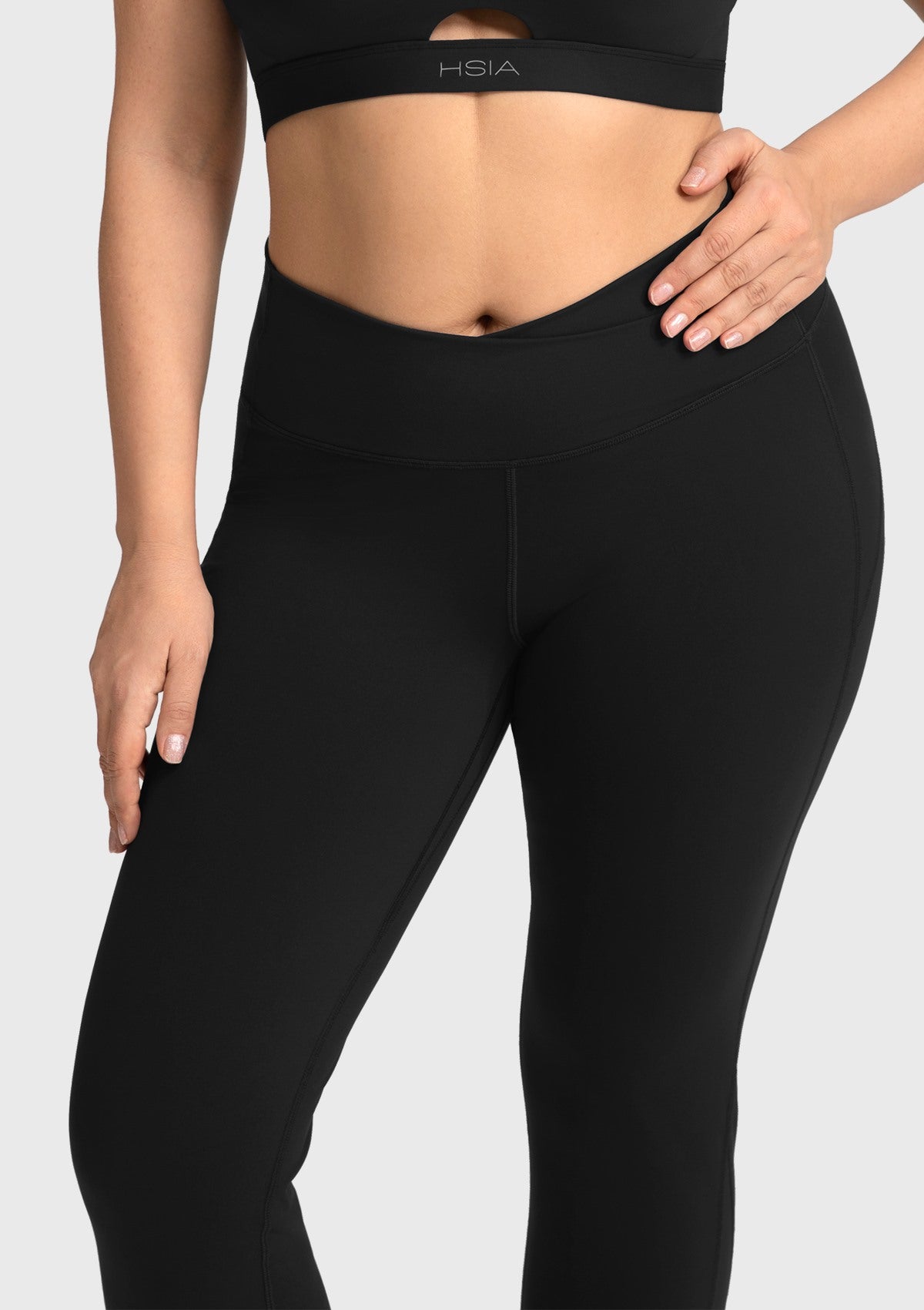Close-up of the black cooling workout leggings, showcasing the premium moisture-wicking fabric and seamless crossover front.