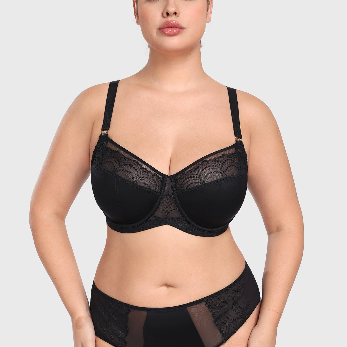 Woman posing confidently in the black French embroidery bra, demonstrating deep cup capacity and a flattering, open neckline without spillage.