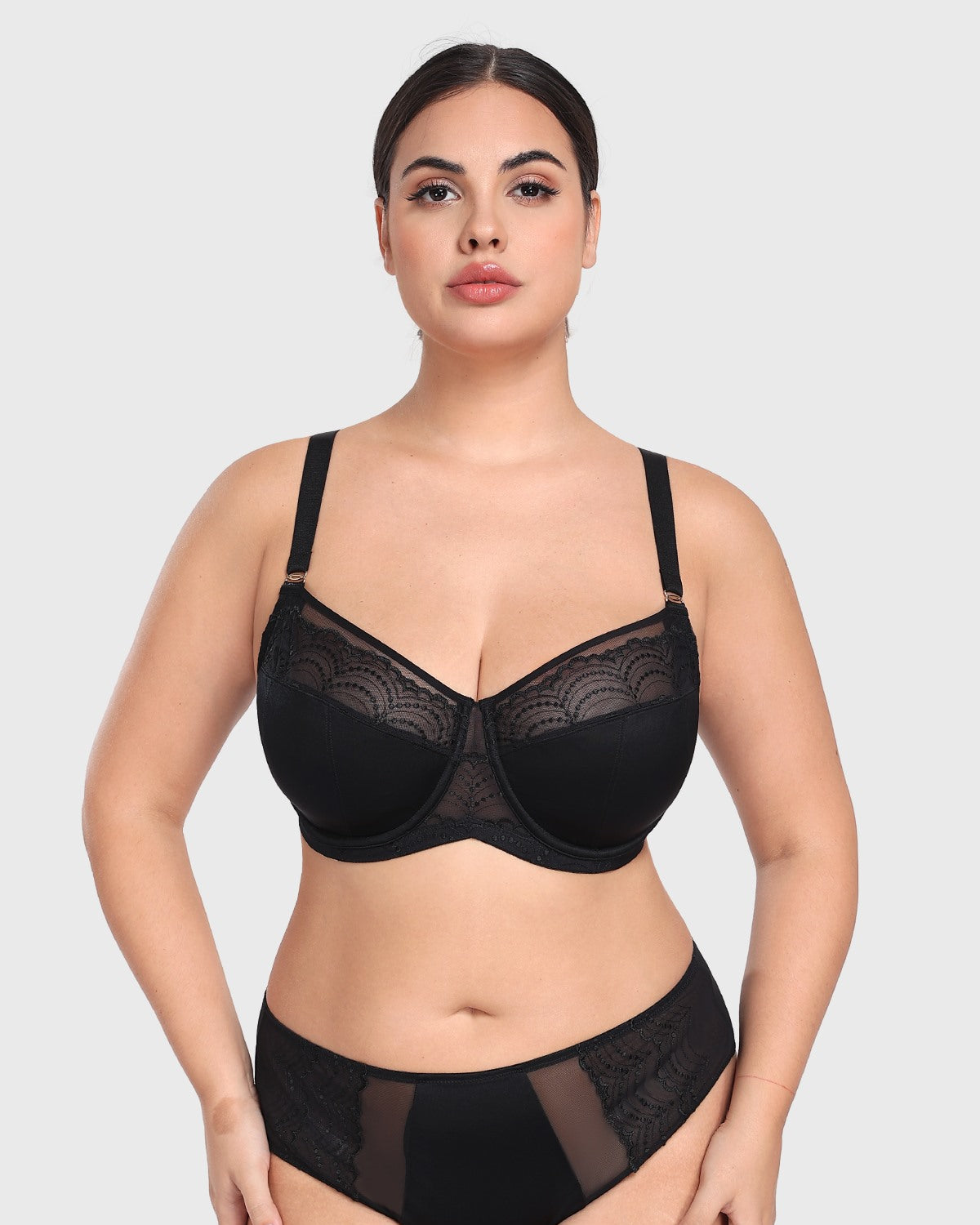 Woman posing confidently in the black French embroidery bra, demonstrating deep cup capacity and a flattering, open neckline without spillage.