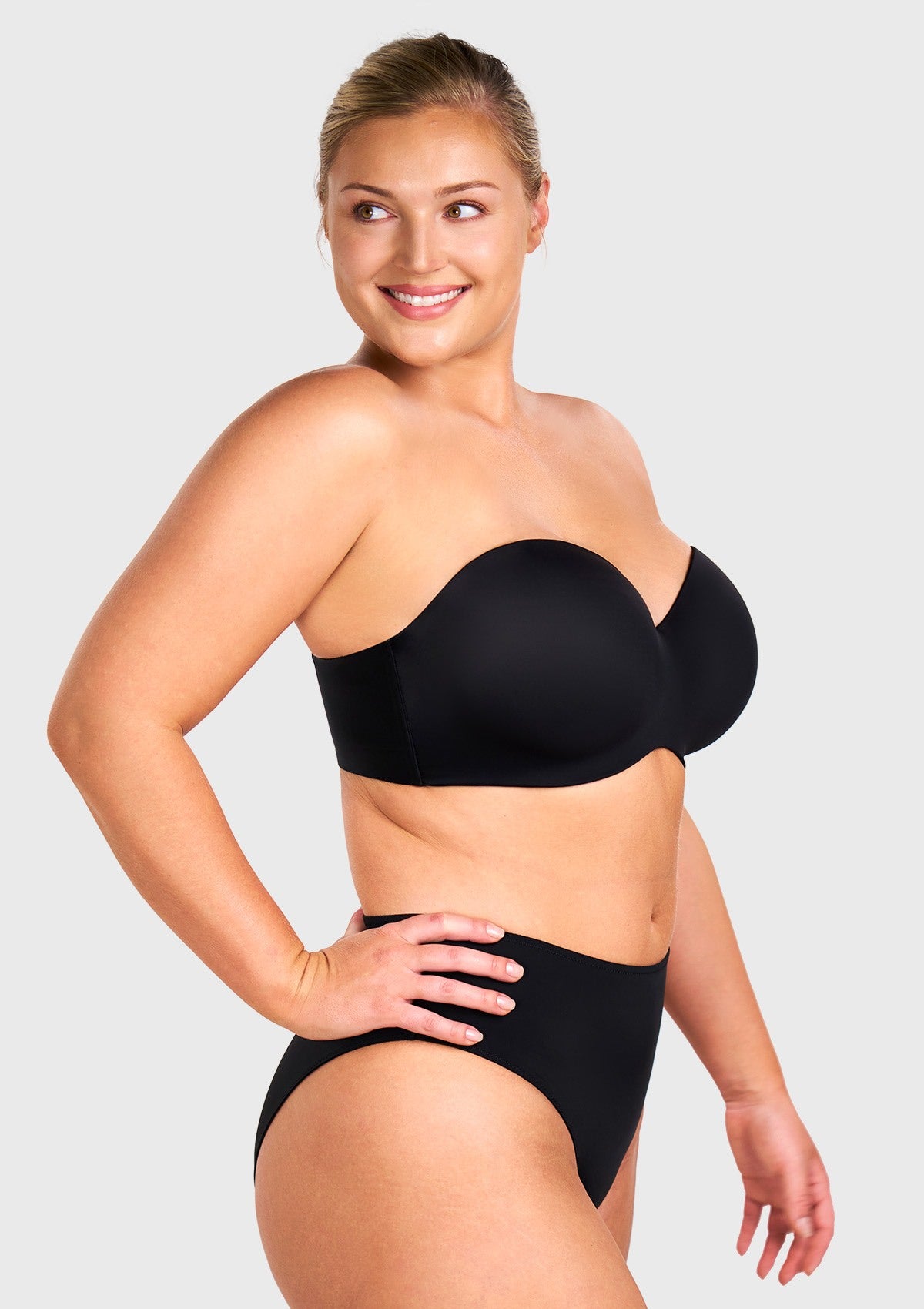 Side view of the comfortable black strapless bra with straps showing supportive shaping