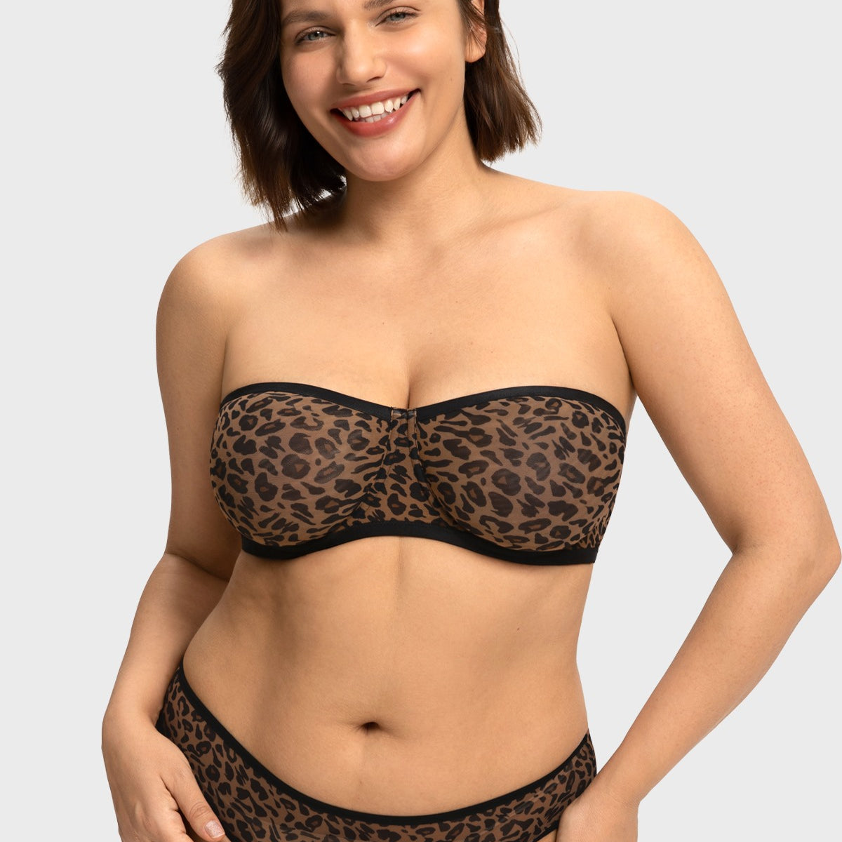 Front view of woman wearing the black leopard unlined strapless minimizer bra