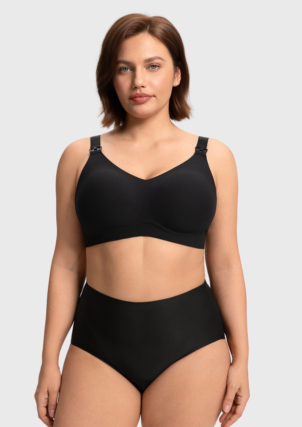 Front view of a model wearing the black SoftContour wireless nursing bra, showing the stylish V-neck design and smooth invisible fit under clothing.