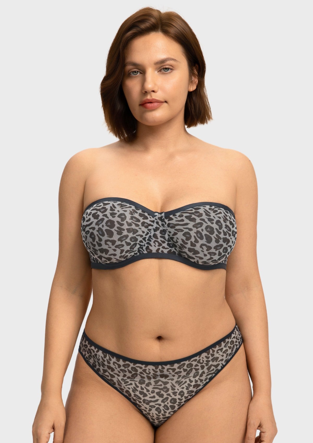 Front view of woman wearing the black and white leopard unlined strapless minimizer bra