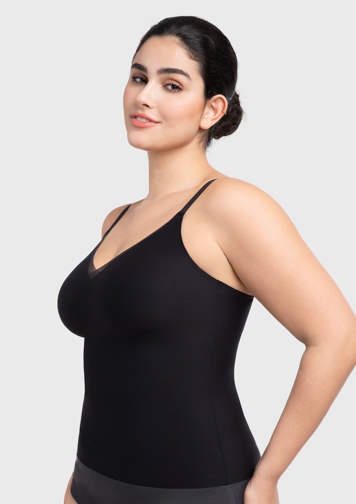 Side profile of the black wire-free camisole with a built-in bra, highlighting the smooth sculpting fit and invisible stitch-free seams.