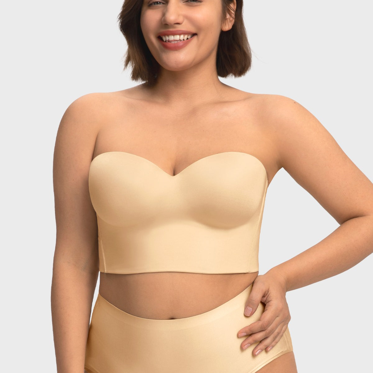 Smiling woman wearing the champagne supportive strapless corset bra, enjoying comfortable, gravity-defying lift for C to I cups.