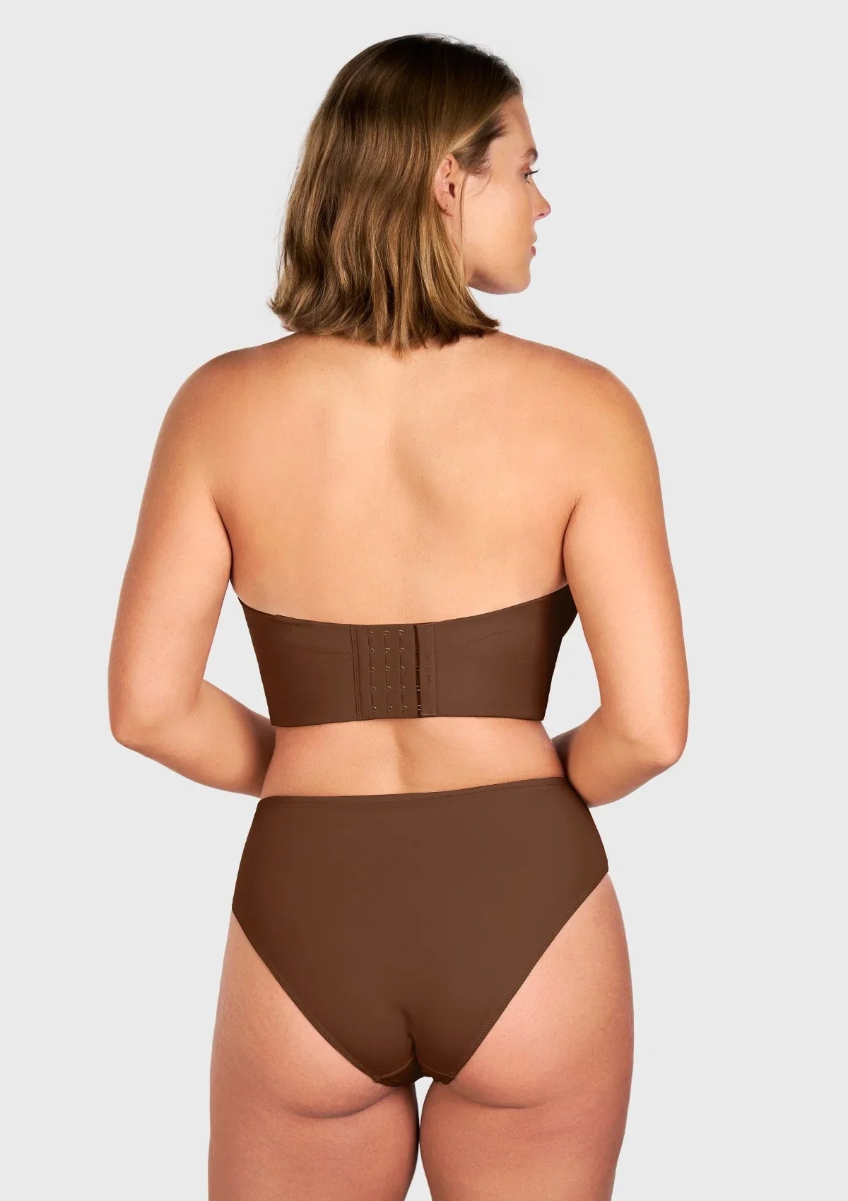Back view of the coffee brown convertible strapless bra, showcasing the breathable back lining and customizable straps for plunging necklines.