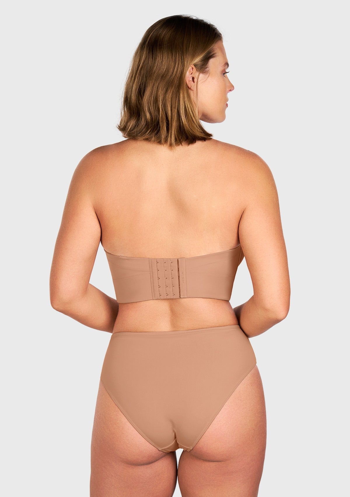 Rear view of the dark beige anti-slip longline bra, featuring a wide, multi-hook back closure that ensures stay-put confidence all day.