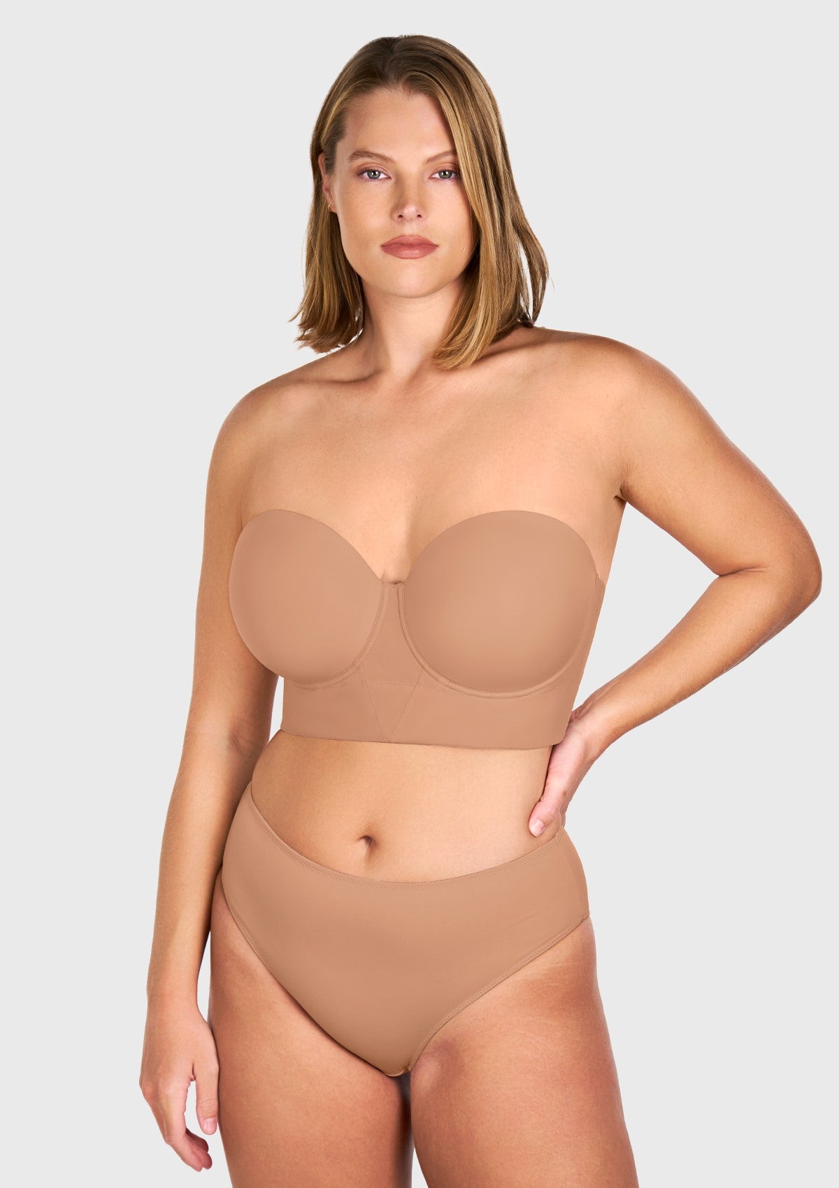 Close-up front view of the dark beige seamless smooth strapless bra, highlighting the sleek, invisible finish and perfectly molded cups.