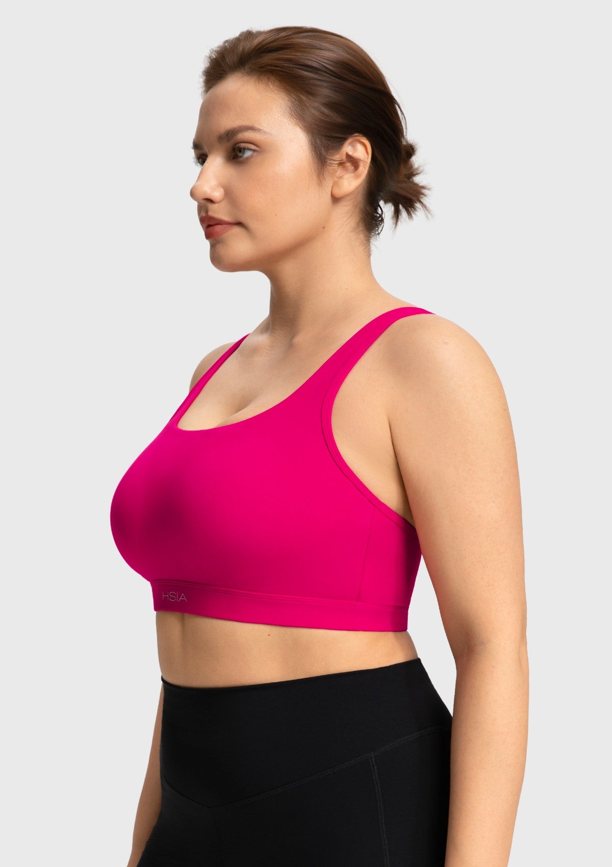 Side profile of the dragon fruit pink Aura workout top showing secure and comfortable coverage