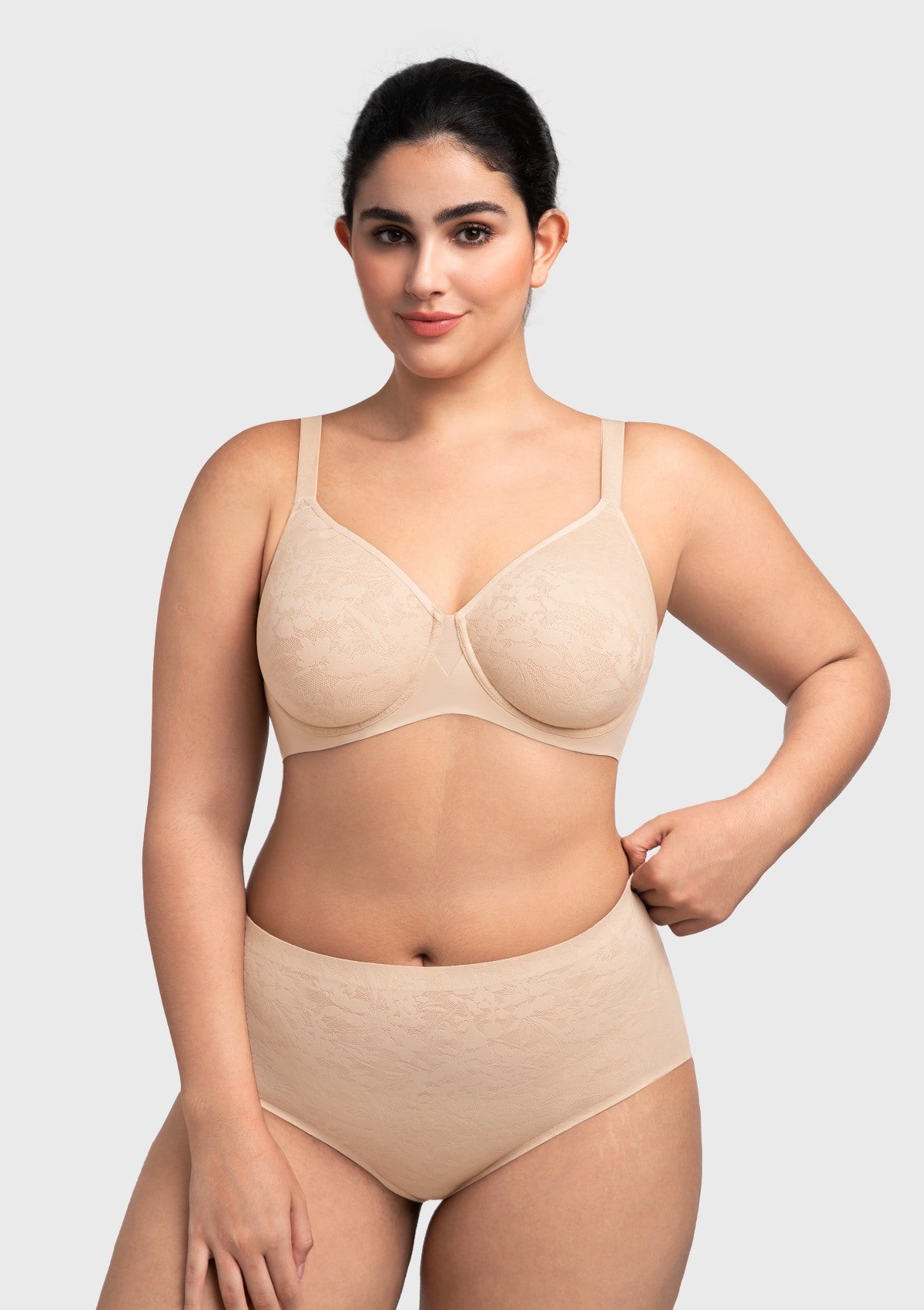 Confident woman with hands on hips wearing the nude supportive underwire bra, highlighting the perfectly smooth silhouette under clothing.