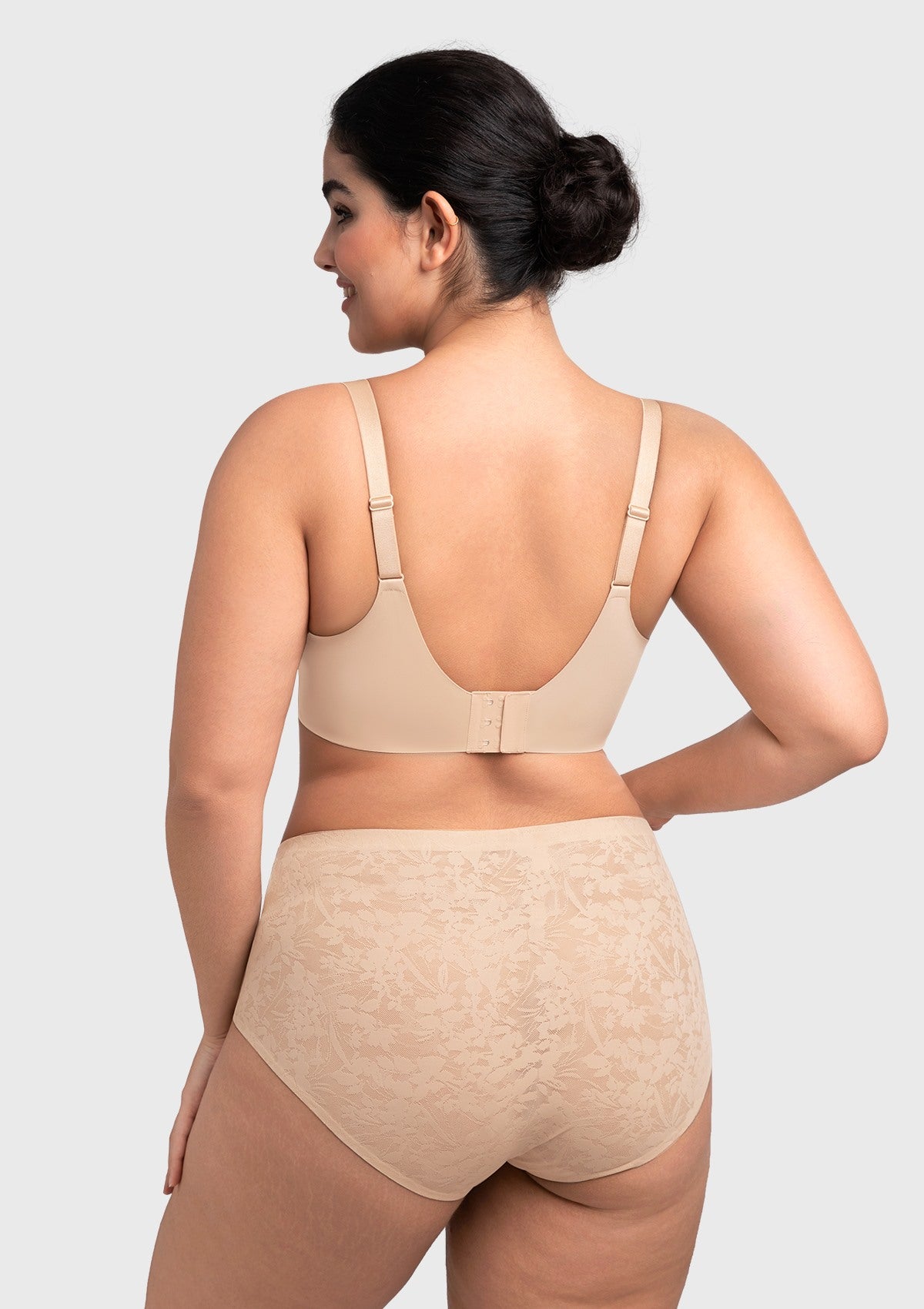 Rear view of the nude seamless lace bra, detailing the wide U-shaped back and adjustable comfort straps for a sleek, modern line.