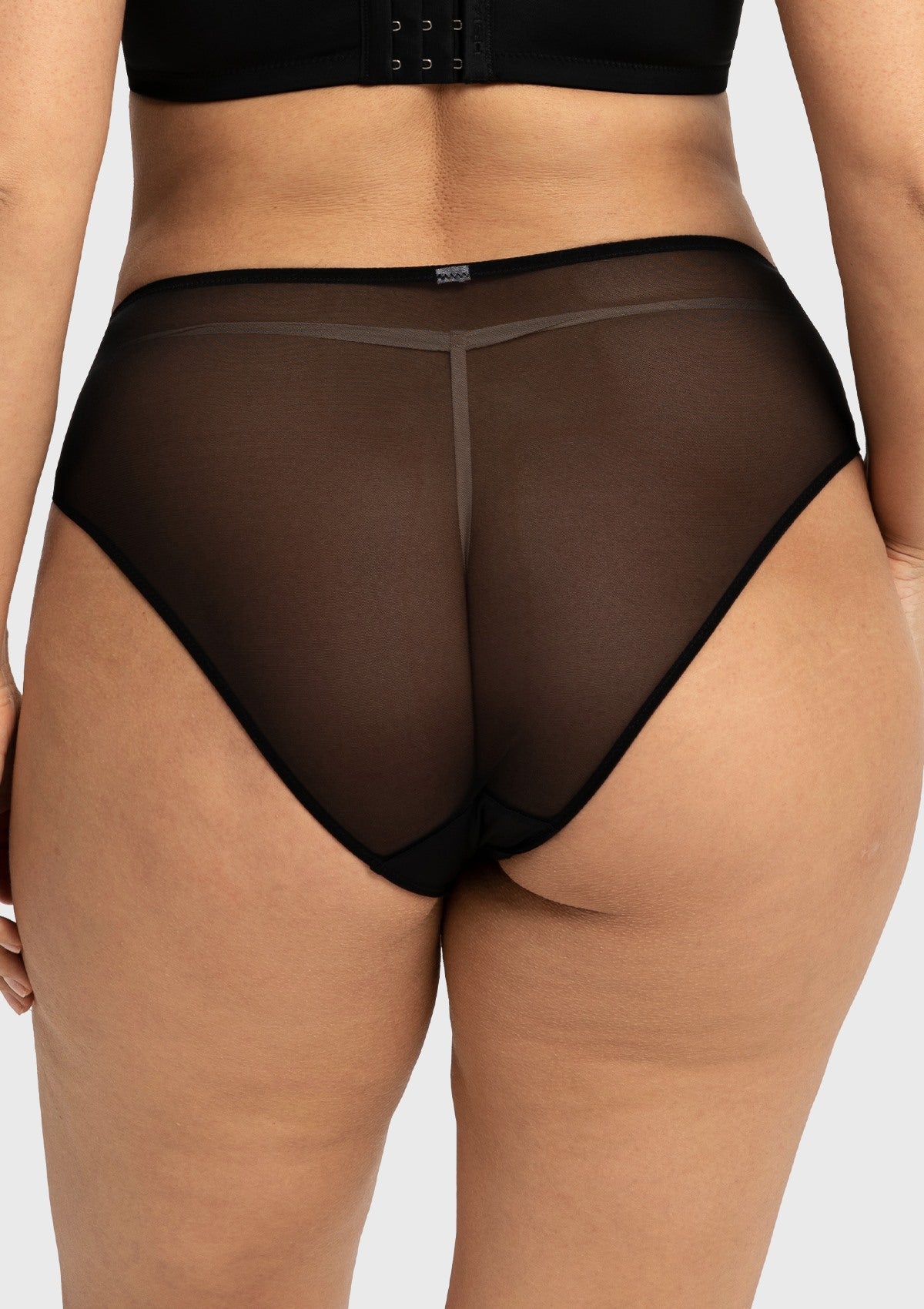 Rear view of the black full coverage panty on model, highlighting the smooth back design that beautifully flatters natural glute lines without digging in.