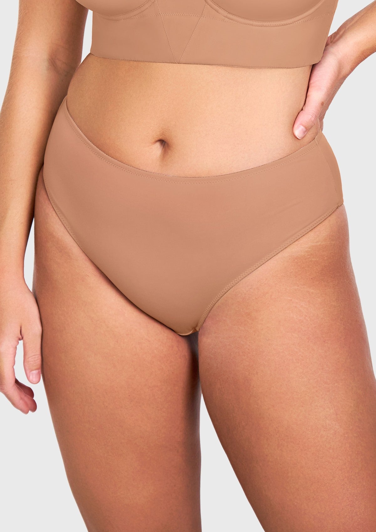 Front view of model in the HSIA dark beige modern high brief panty, designed to be completely invisible under everyday light-colored clothing.