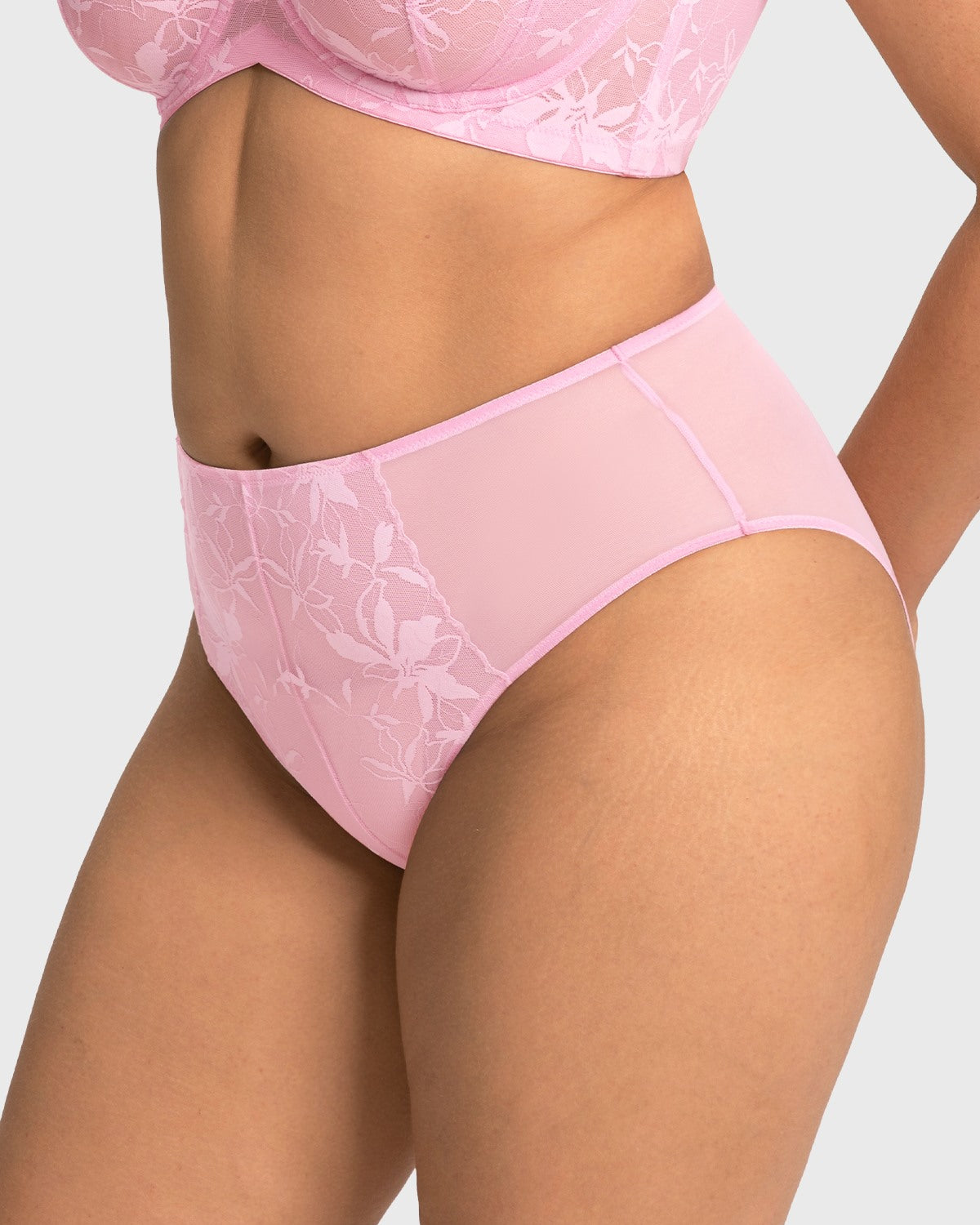 Side profile of model in the soft pink high waist lace panty, showcasing the high-quality elastic waist that never digs in.