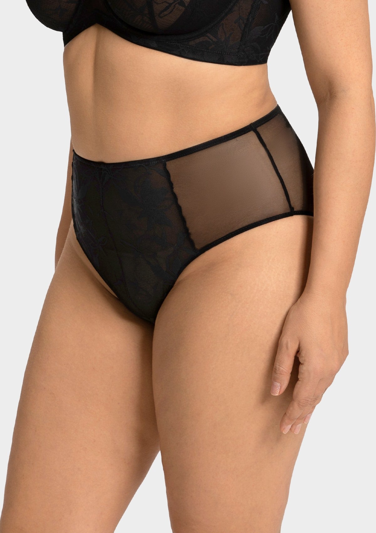 Side profile of model wearing the black sexy high waist panty, showcasing the flattering smoothing fit and chic silhouette.