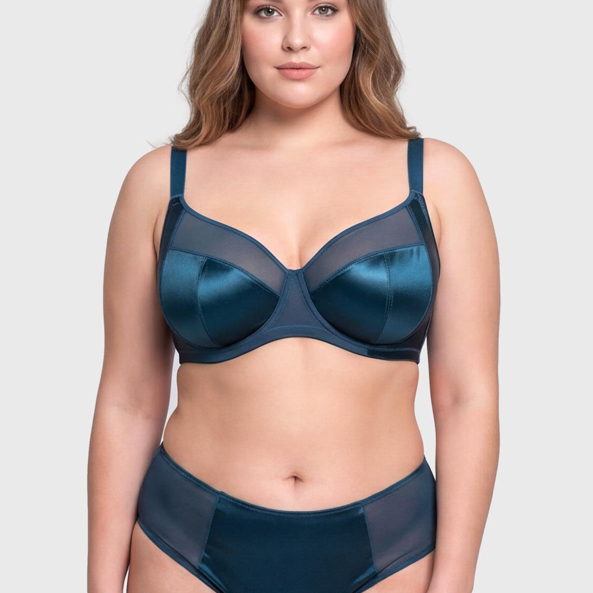 Front view of model wearing the vibrant Ocean Blue HSIA Lunaire shimmer unlined bra, featuring sensual sheer mesh and heavy-duty support up to L cup.