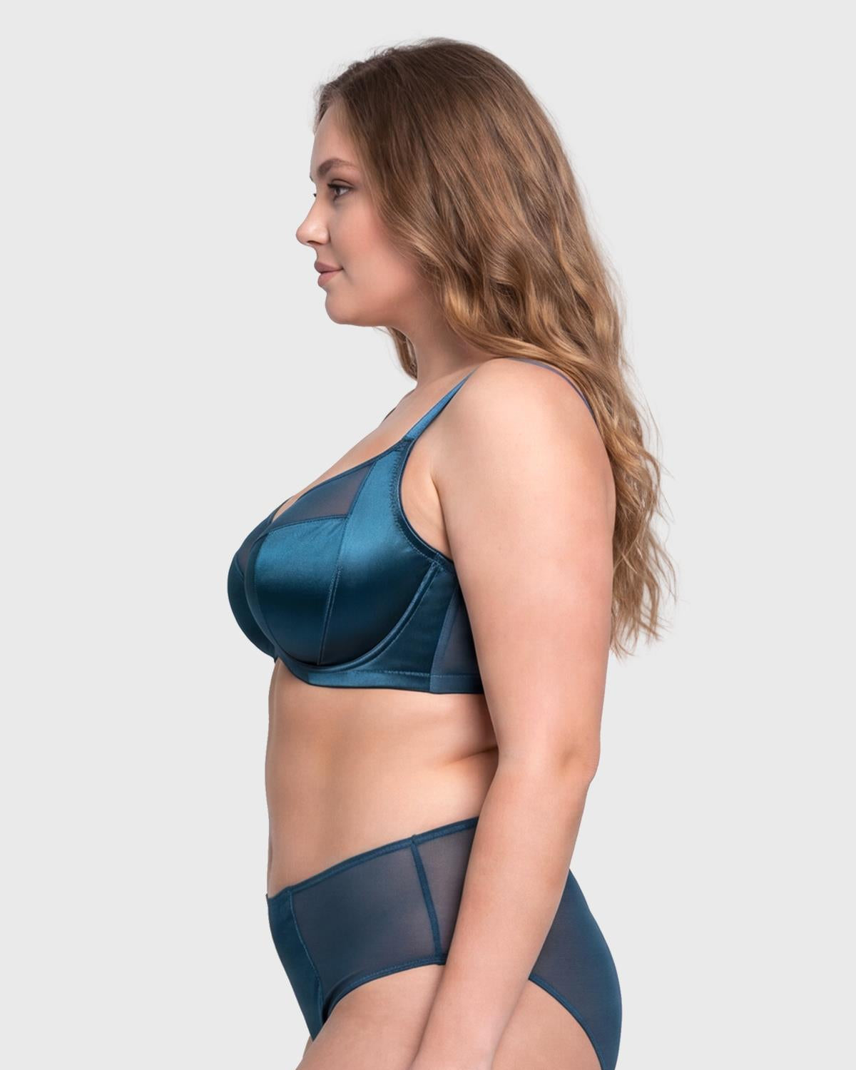 Side profile of the Ocean Blue Lunaire T-shape bra on model, showcasing the built-in side slings that eliminate side boob for big busted women.