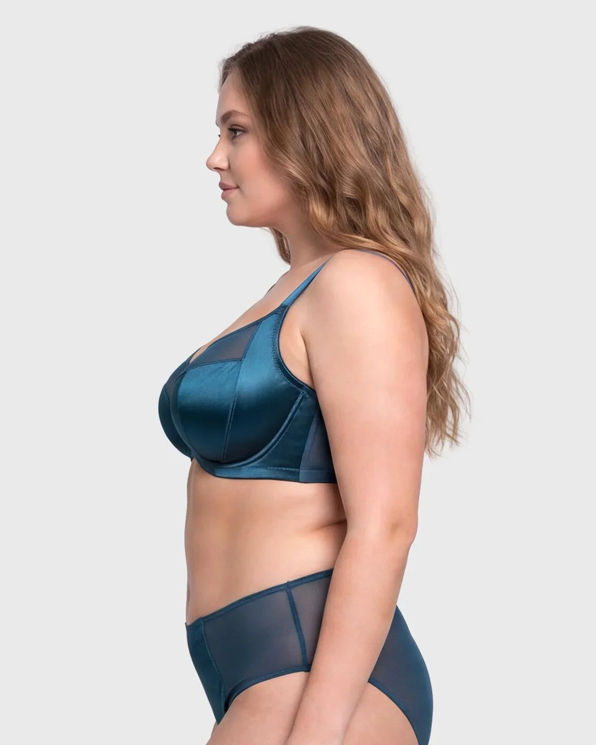 Side profile of the Ocean Blue Lunaire T-shape bra on model, showcasing the built-in side slings that eliminate side boob for big busted women.