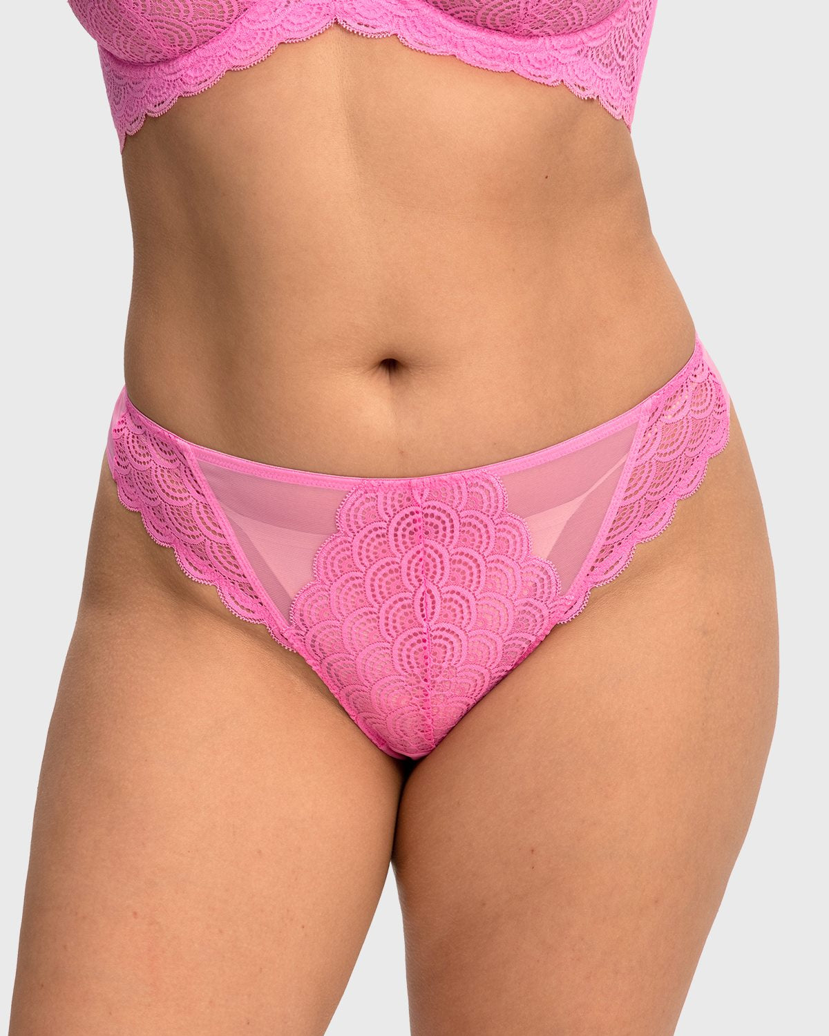 Front view of model wearing the HSIA medium pink women's lace high waist thong panty, featuring a flattering stretch mermaid scale design.