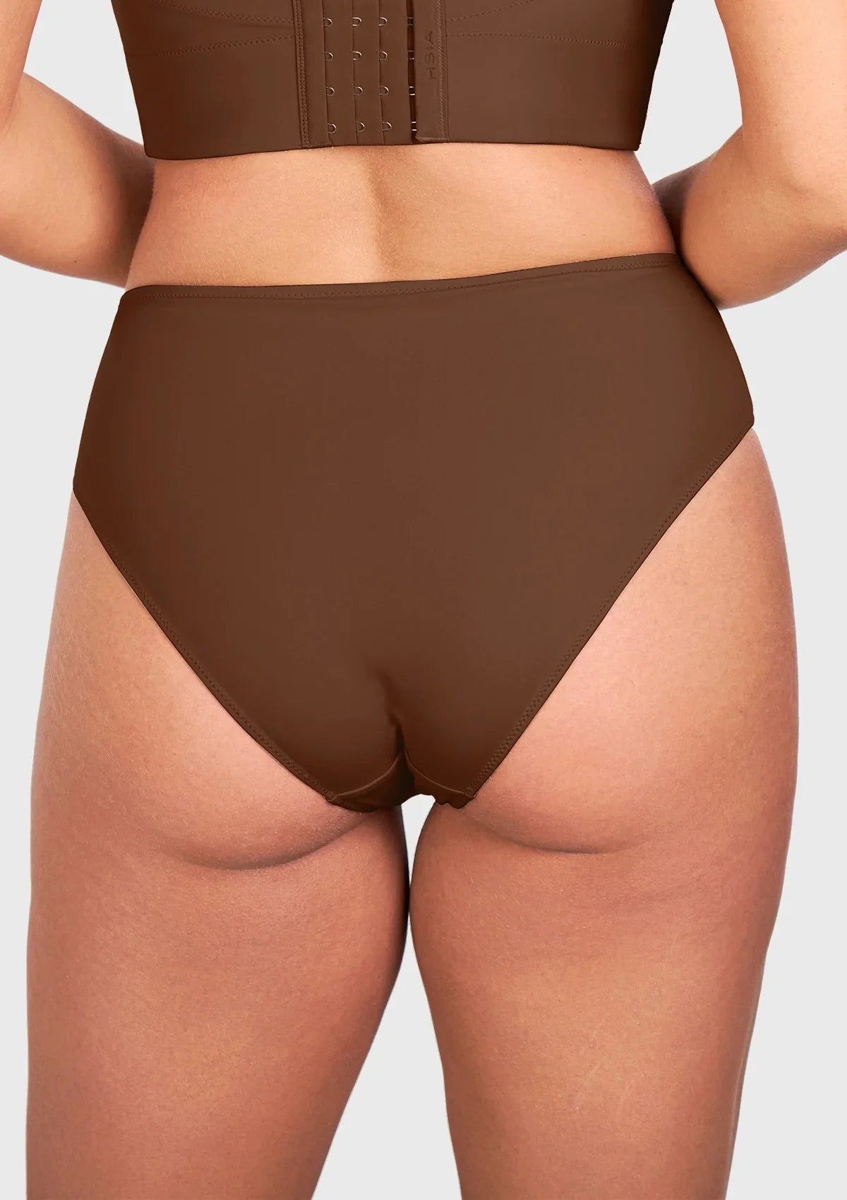 Back view of model in the coffee brown high waist seamless underwear, ensuring a secure and flattering fit for changing body shapes.