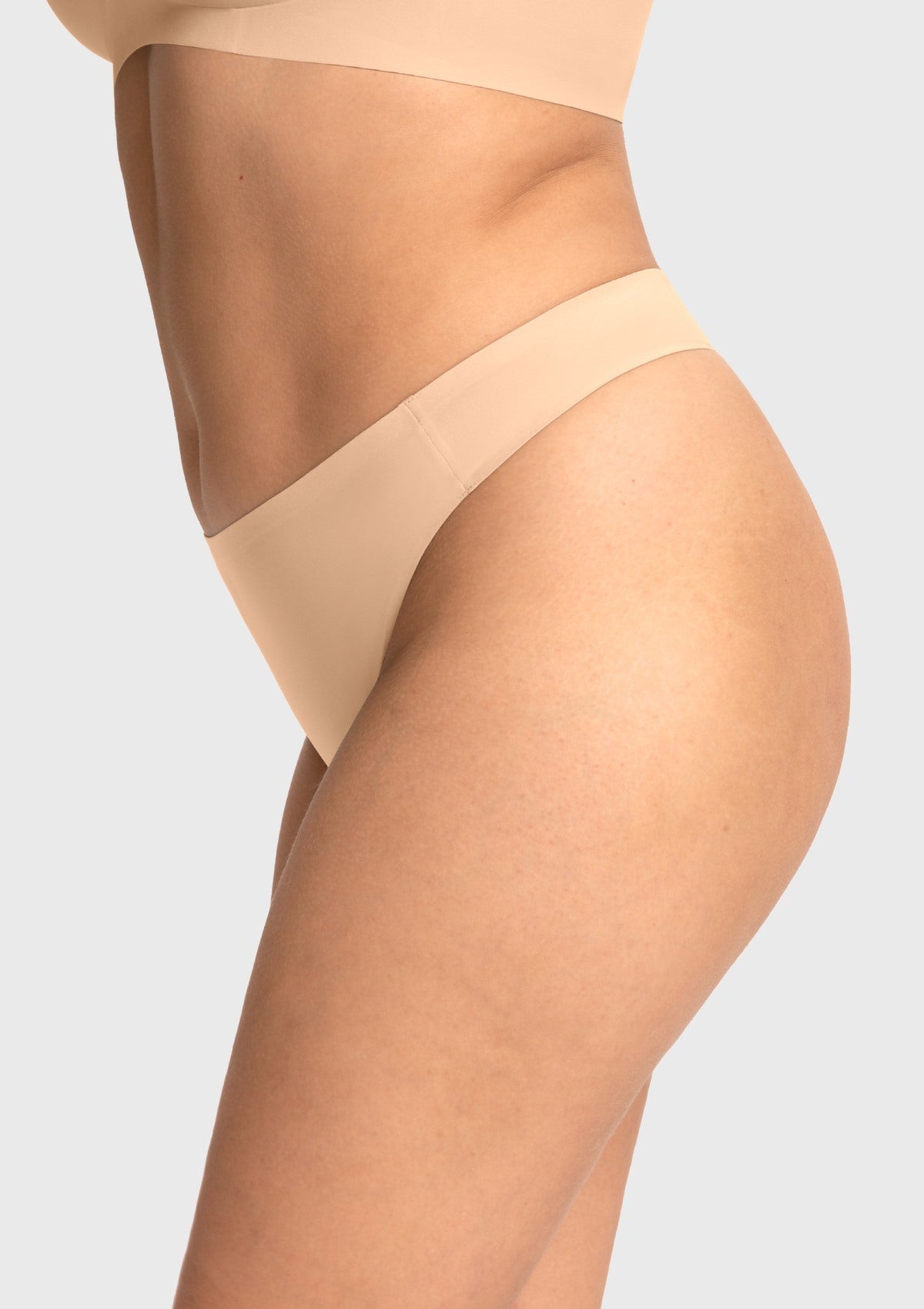 Side view of the beige invisible thong, showcasing the second-skin feel that remains undetectable under body-hugging outfits.