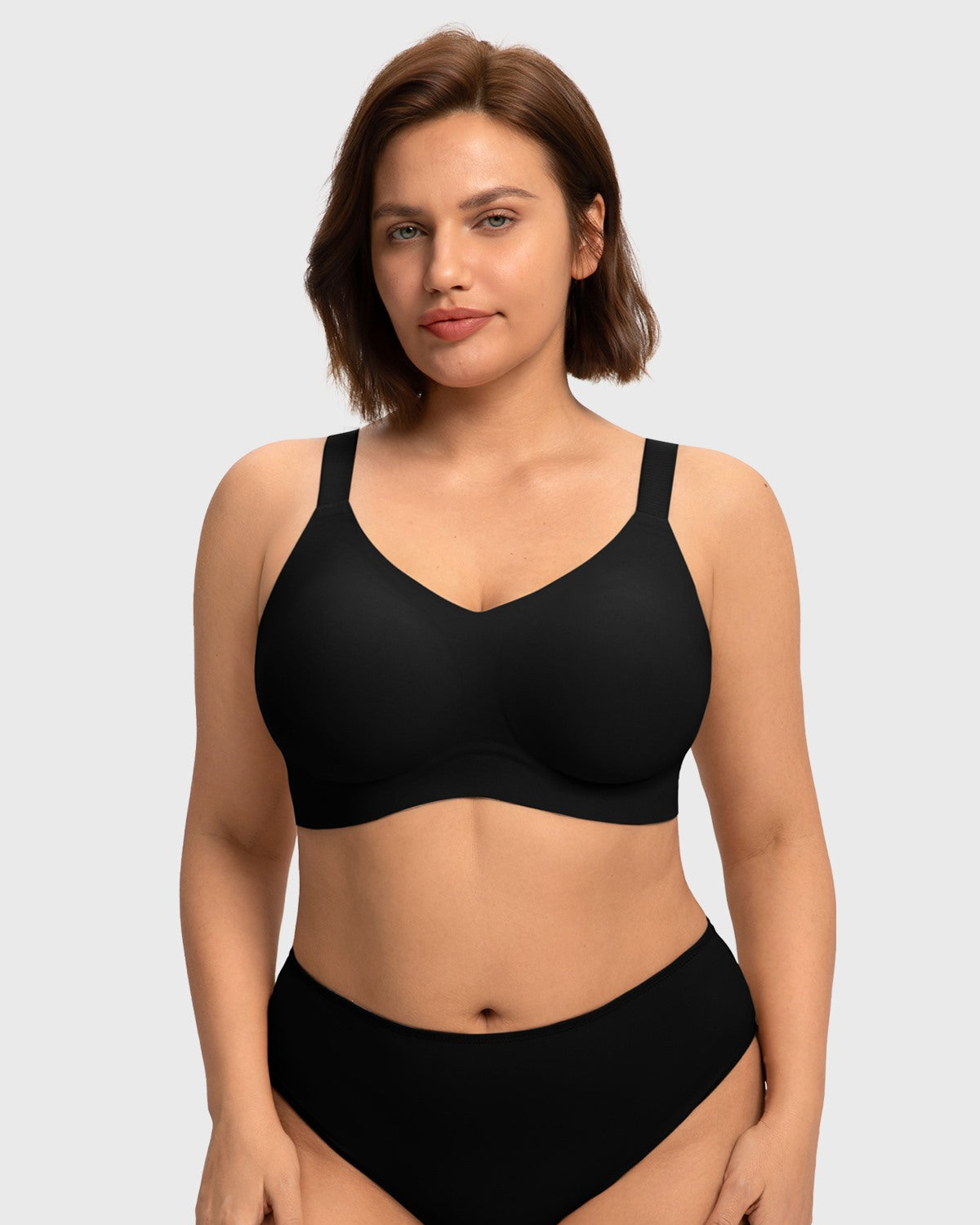 Close-up front view of the black wireless full coverage bra on model, highlighting the breathable, moisture-wicking stretch fabric that feels like a second skin.
