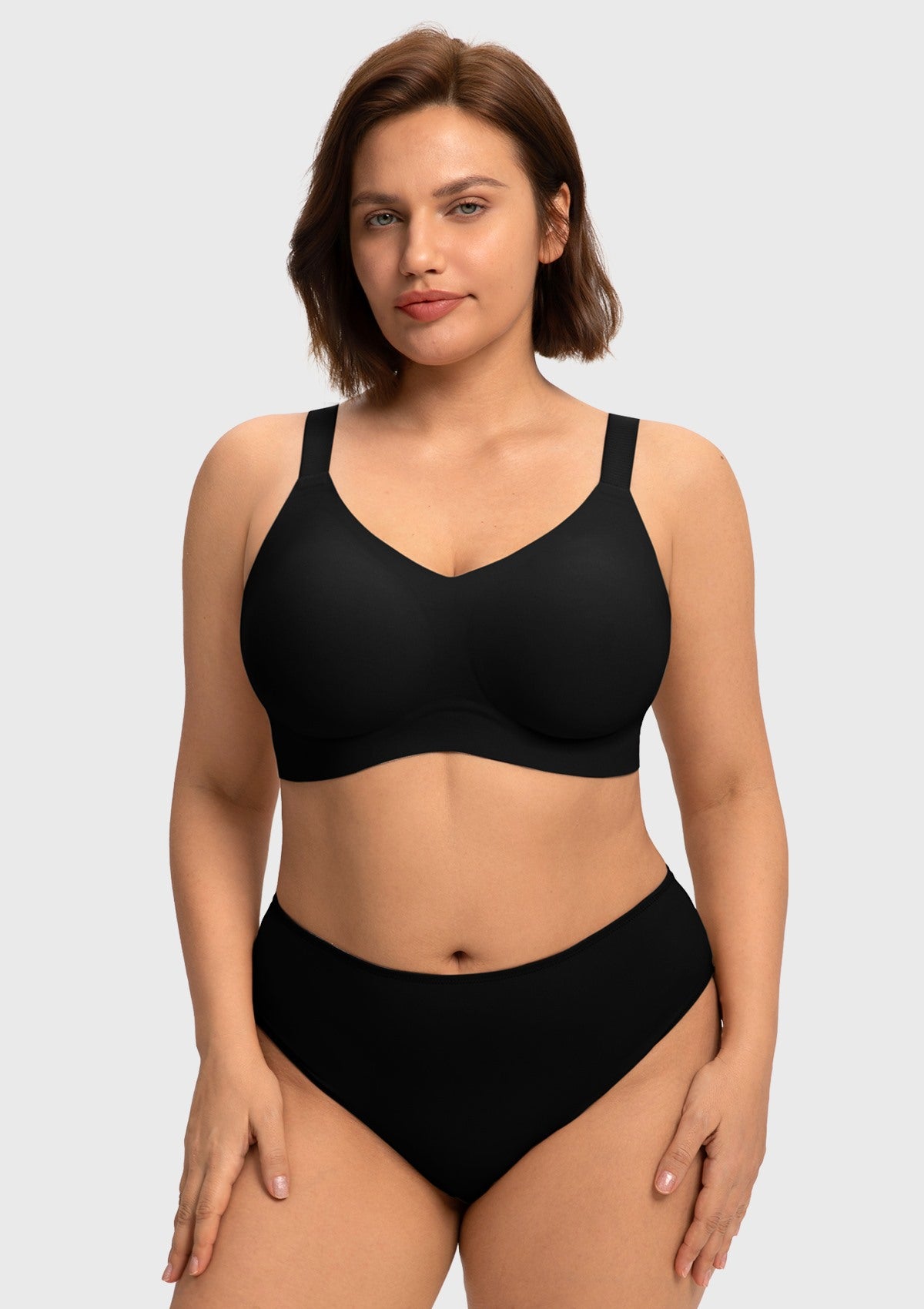 Close-up front view of the black wireless full coverage bra on model, highlighting the breathable, moisture-wicking stretch fabric that feels like a second skin.