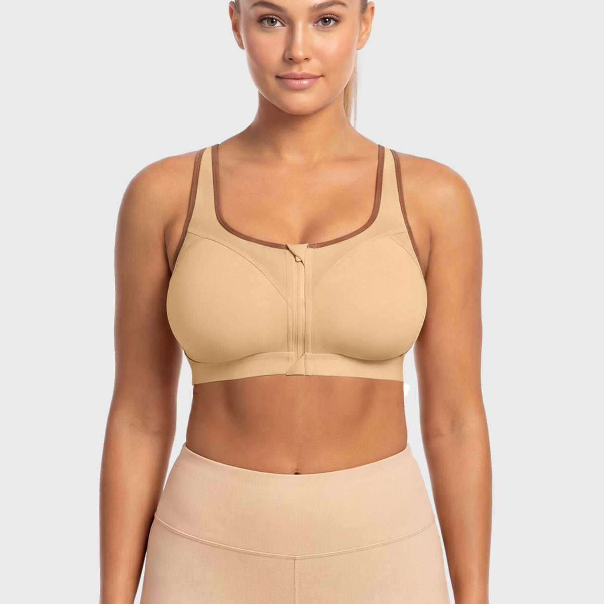 Front view of model wearing the Warm Beige HSIA front closure sports bra, delivering heavy-duty lockdown support and effortless on-and-off convenience.