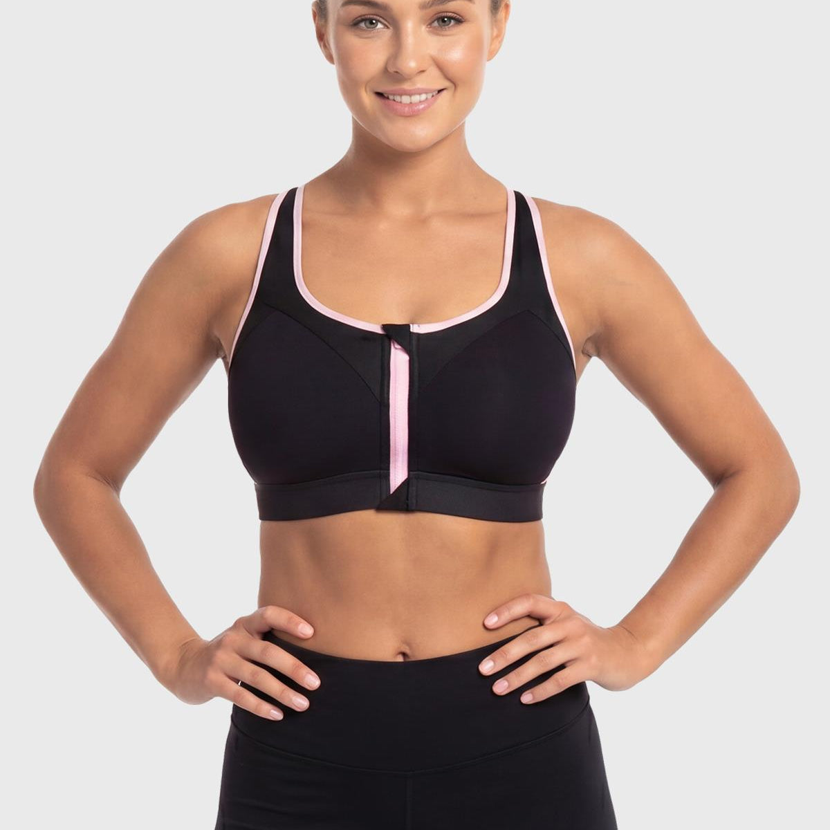 Front view of model in the classic Black HSIA Speed Race front closure sports bra, an effortless and supportive post surgery front zip bra for large busts.