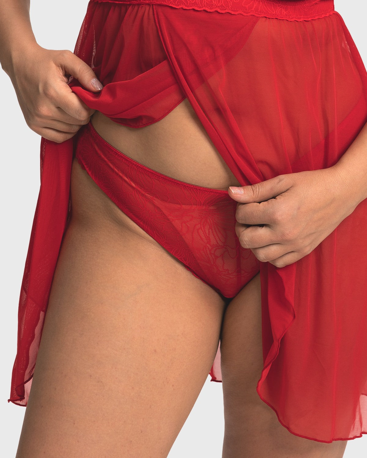Model wearing the Coral Red HSIA Stella sheer floral lace bikini panty, showcasing the flattering classic cut and smooth edges that prevent digging.
