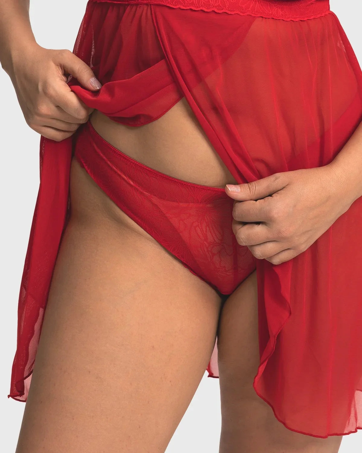 Model wearing the Coral Red HSIA Stella sheer floral lace bikini panty, showcasing the flattering classic cut and smooth edges that prevent digging.