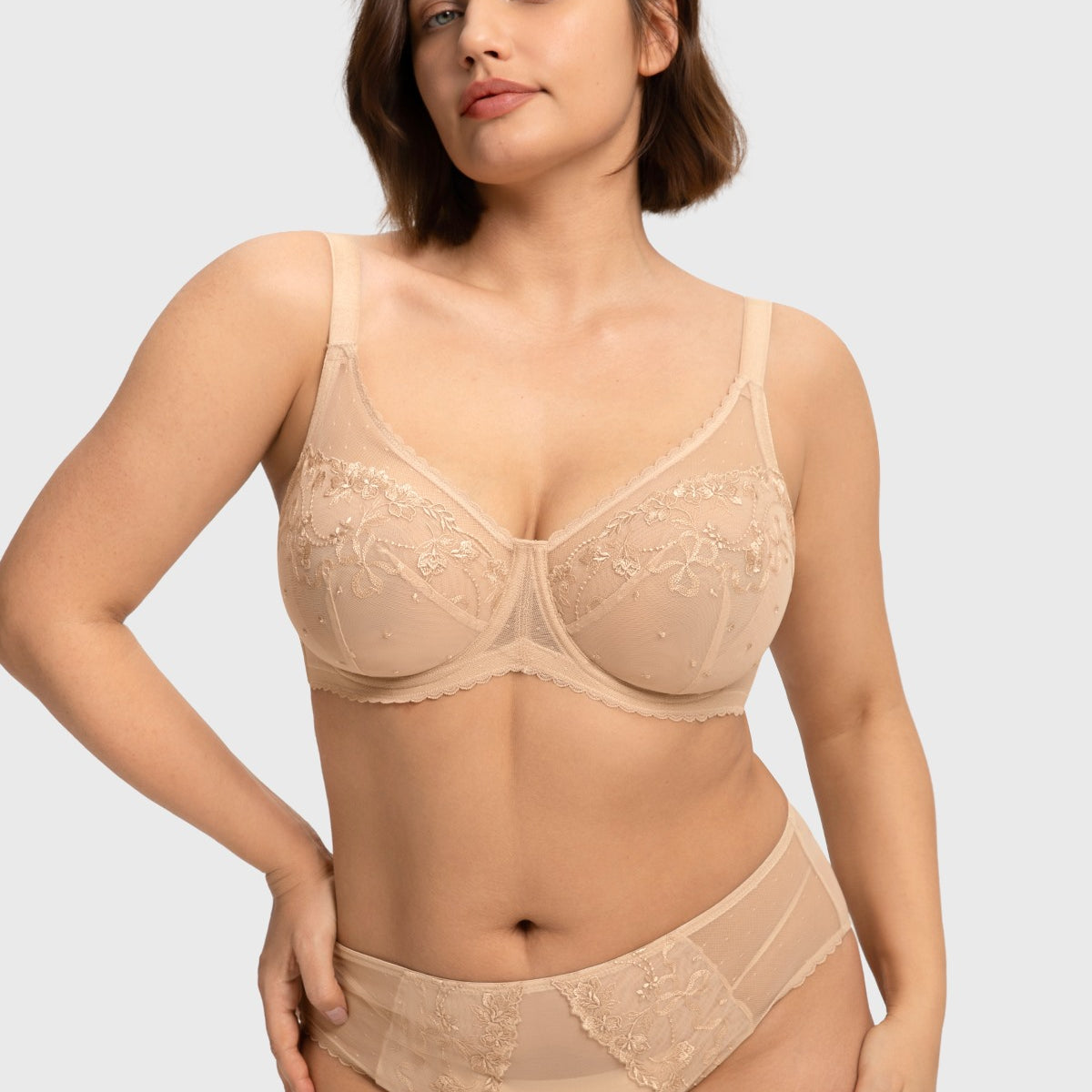 Front view of the light beige embroidered lace full coverage bra, showcasing a spill-free polka-dot neckline designed for heavy breasts.