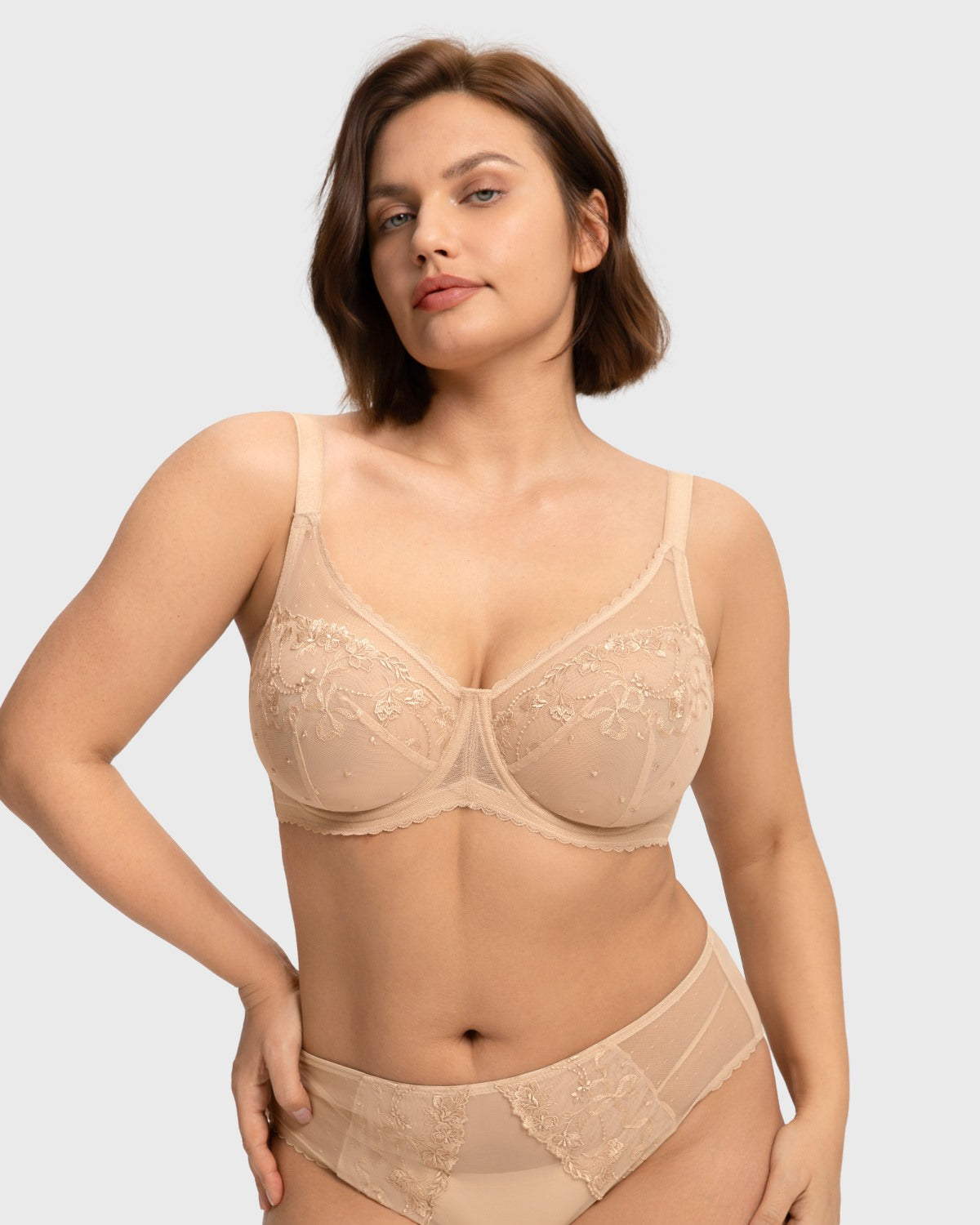 Front view of the light beige embroidered lace full coverage bra, showcasing a spill-free polka-dot neckline designed for heavy breasts.