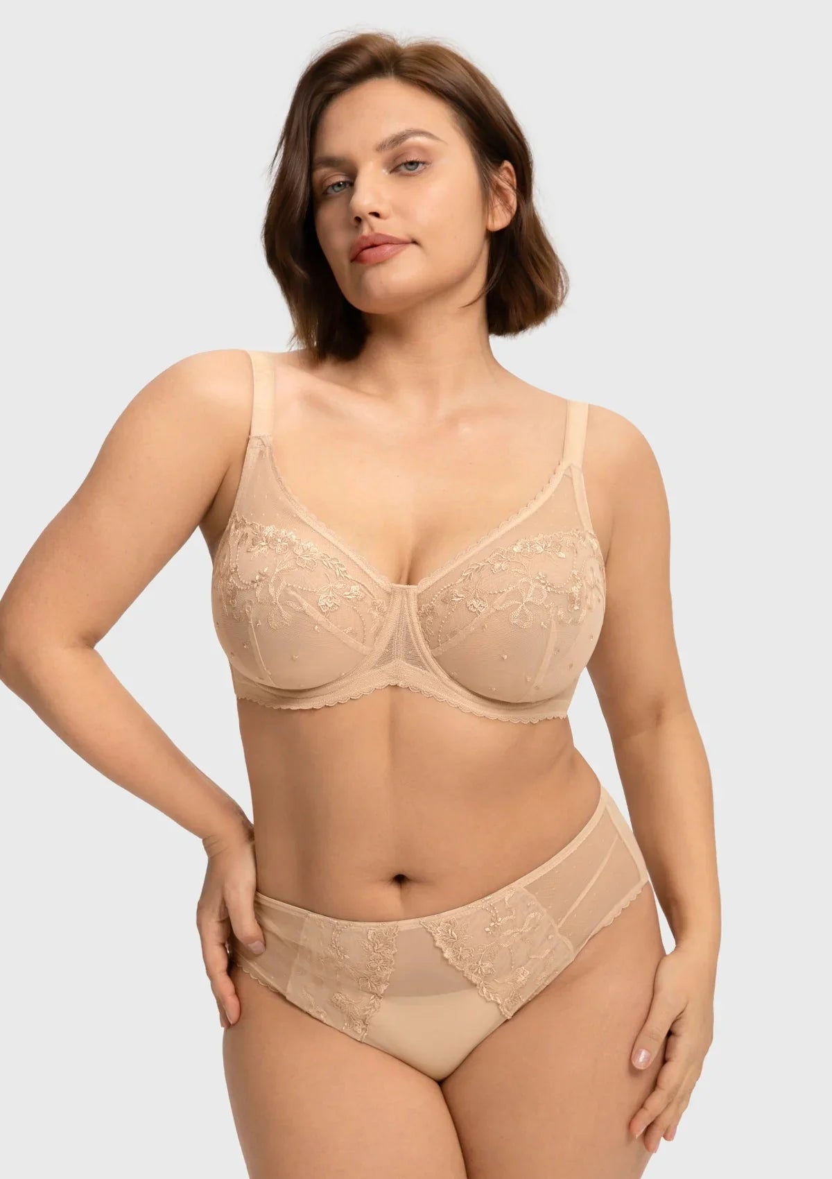 Front view of the light beige embroidered lace full coverage bra, showcasing a spill-free polka-dot neckline designed for heavy breasts.