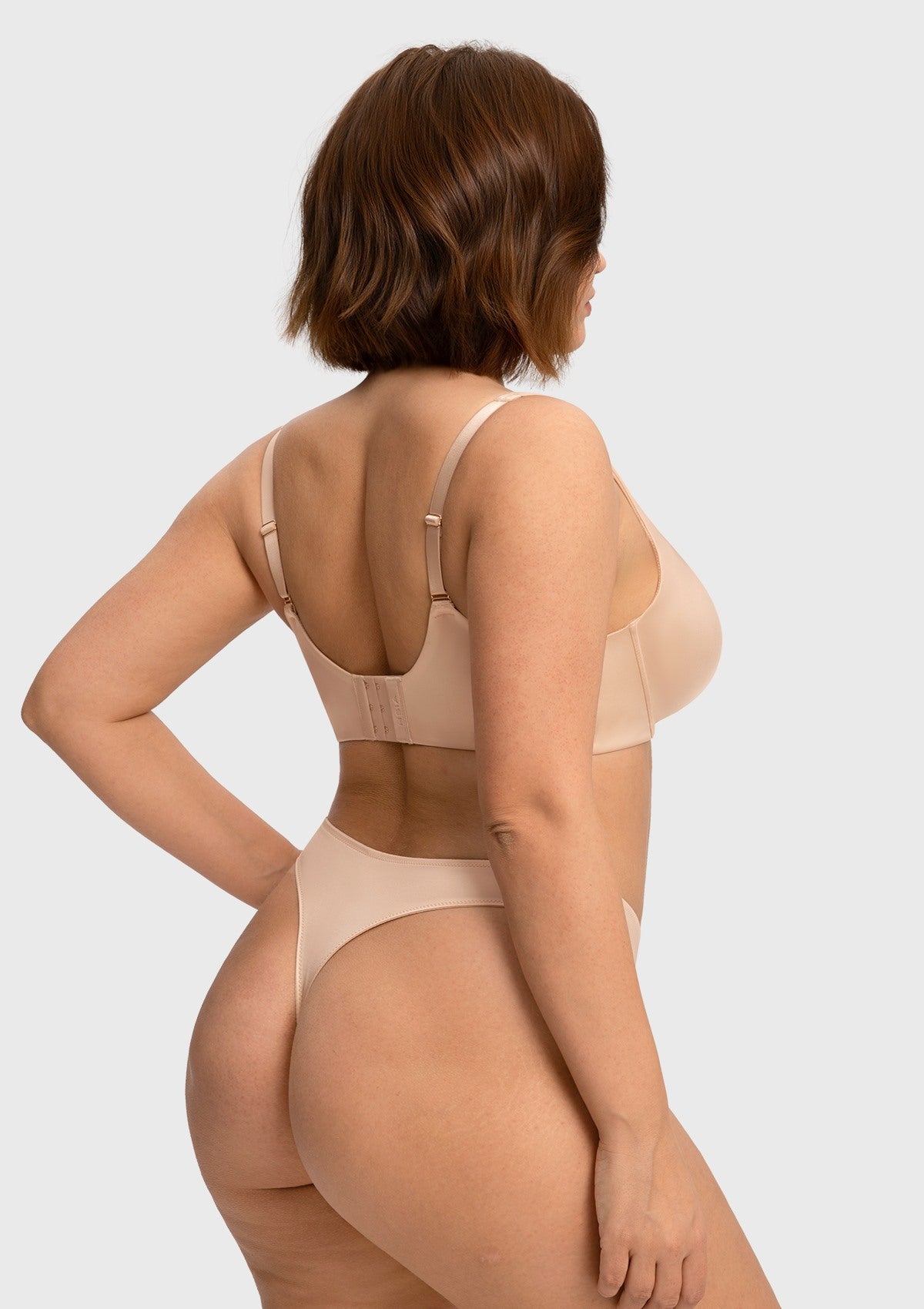 Rear view of the light beige smoothing U-back bra, featuring soft stretch satin and zero-pressure straps for comfortable everyday wear.