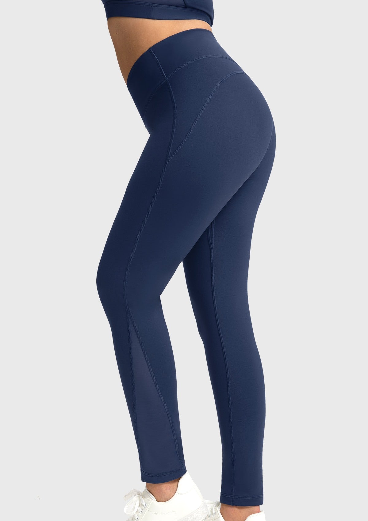 Side angle of the navy blue breathable gym pants highlighting the strategic mesh panels that significantly enhance airflow during intense workouts.
