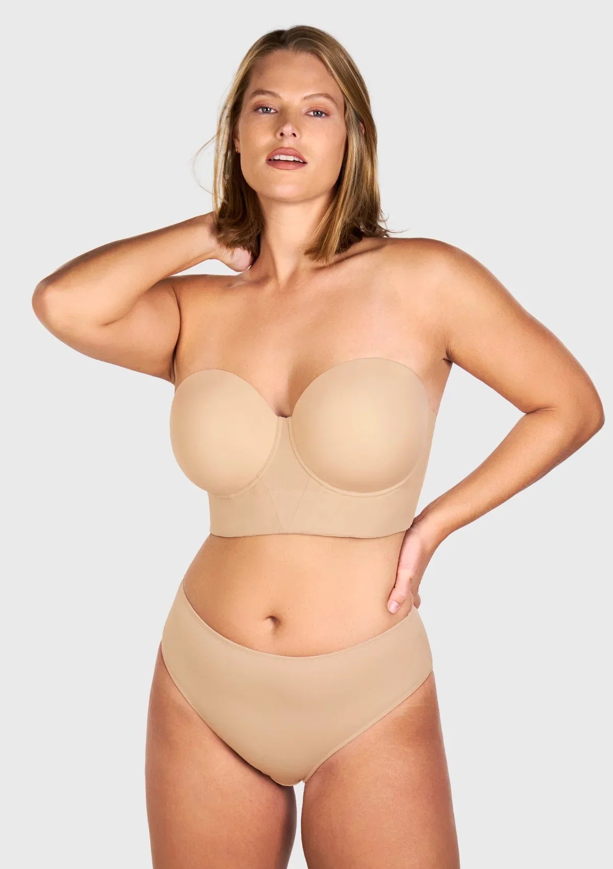 Confident woman wearing the most comfortable strapless bra that stays up, featuring an advanced 8-bone support system.