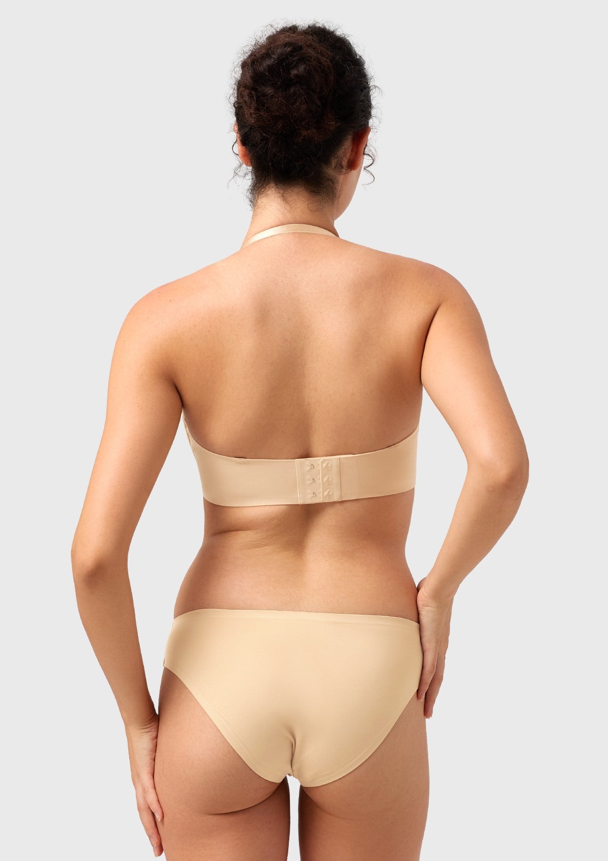 Rear view of the nude convertible bra styled as a halter, perfectly adapting to provide hidden support for your favorite halter tops and dresses.