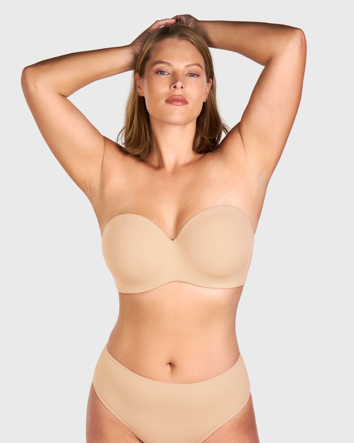 Front view of woman wearing the black HSIA seamless non-slip strapless bra