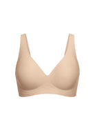 A seamless, wireless bra in a light beige nude color, shown against a plain white background.