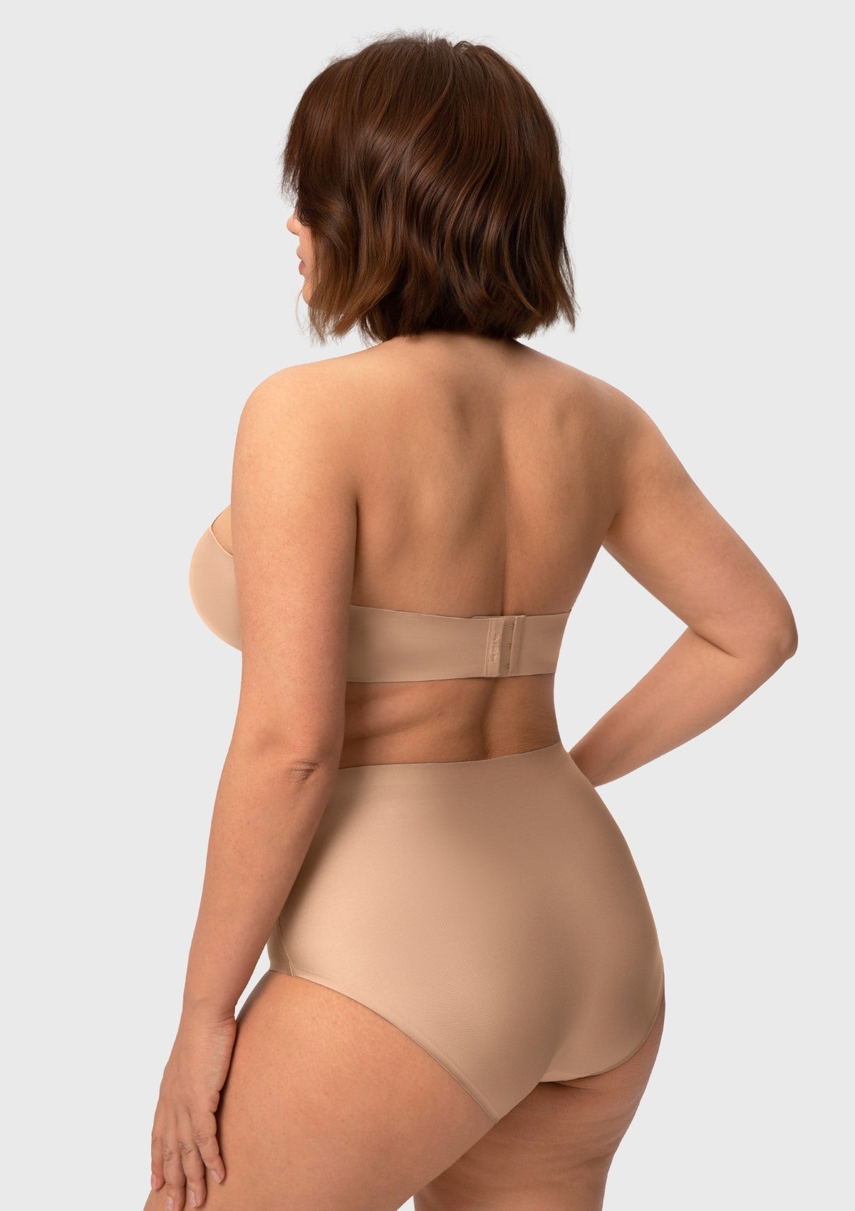 Rear view of the almond skin breathable strapless bra, featuring smooth wings that stay securely anchored without leaving red marks.