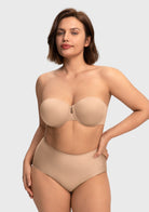Confident woman wearing the almond skin invisible padded strapless bra, experiencing gentle shaping and superior, silicone-free hold.