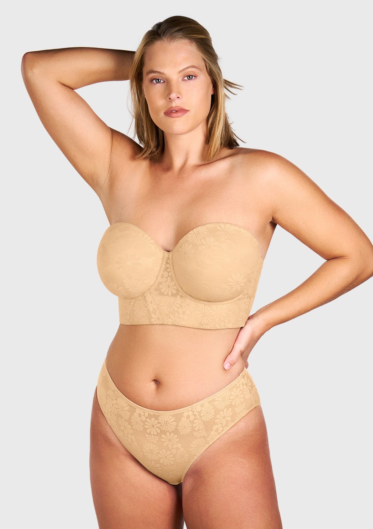 Woman raising her arms in the beige anti-slip strapless bra, demonstrating the secure stay-put grip and double-layer lift system without slipping.