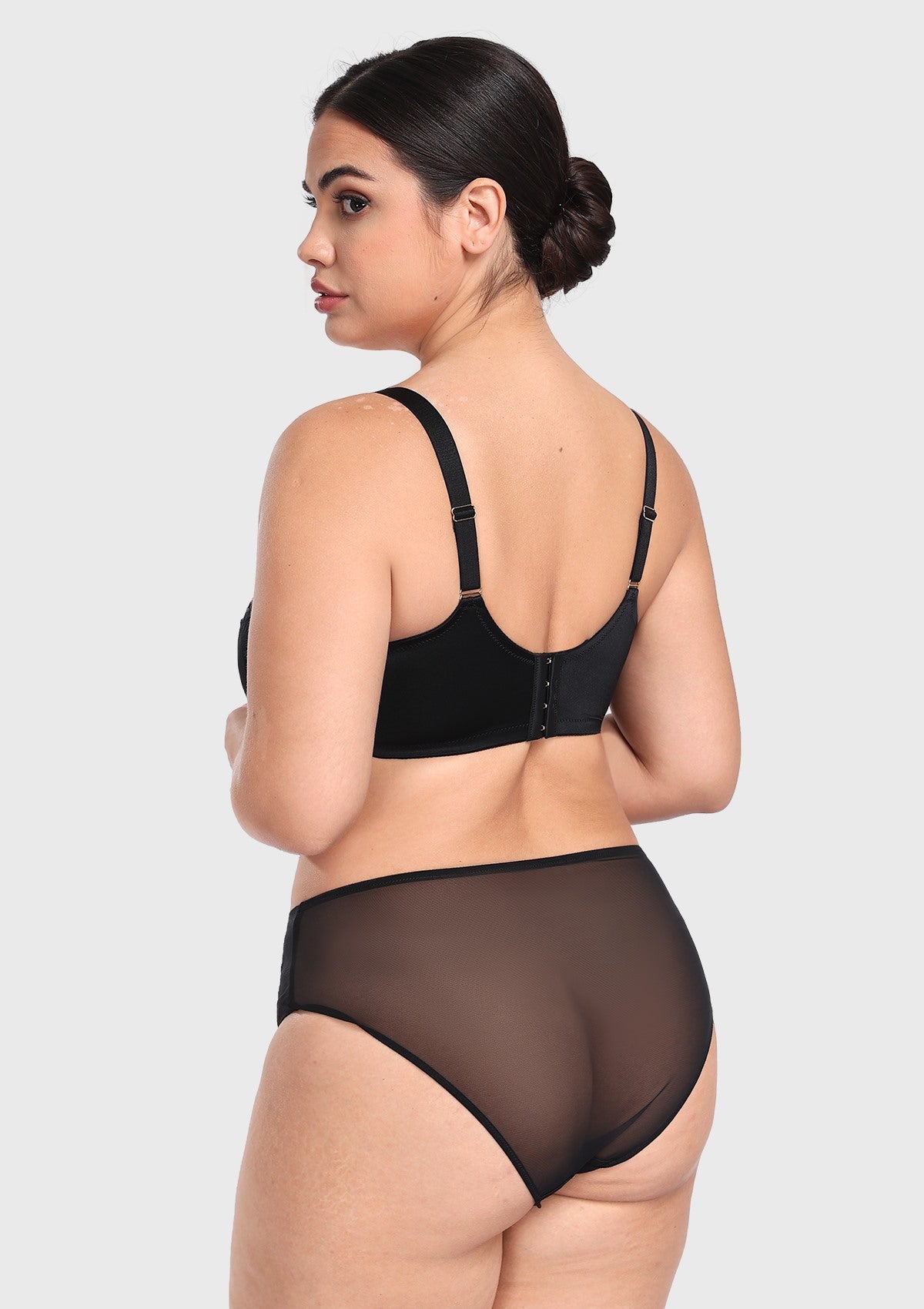  Back view of the black breathable mesh back bra, showcasing the secure multi-row hook closure that intentionally scales with your cup size.